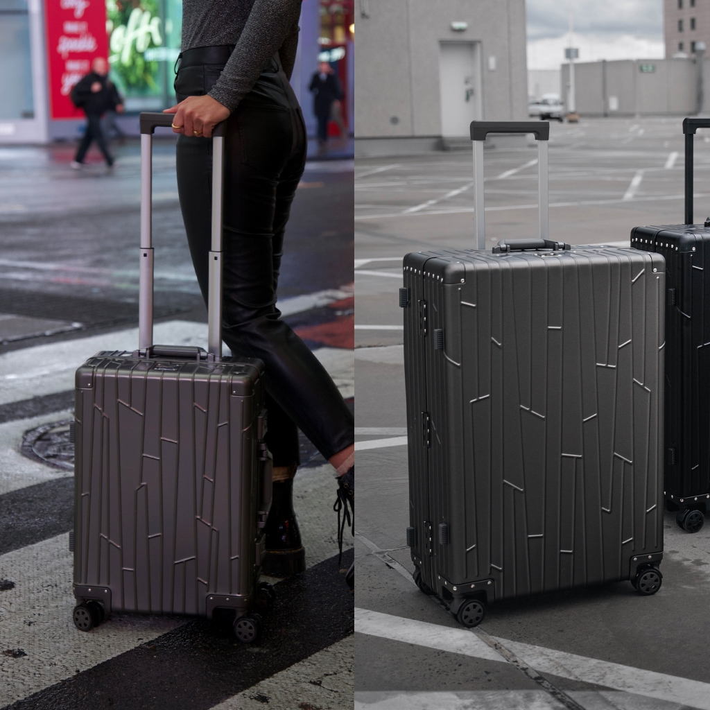 Preview: Zwei GUNDEL Koffer in Space Grau, schräg stehend, mit Linienmuster, Teleskopgriffen und TSA-Schlössern vor weißem Hintergrund.