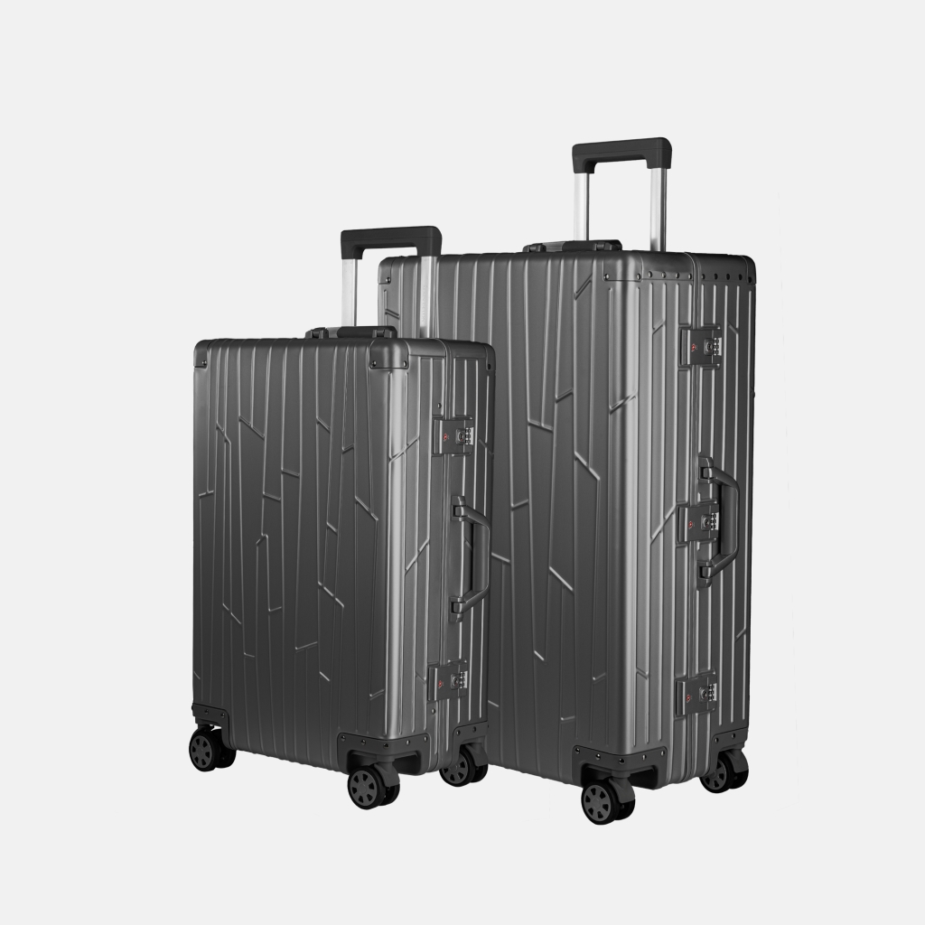 Deux valises GUNDEL gris sidéral en aluminium, inclinée, avec motif de lignes et poignée télescopique.