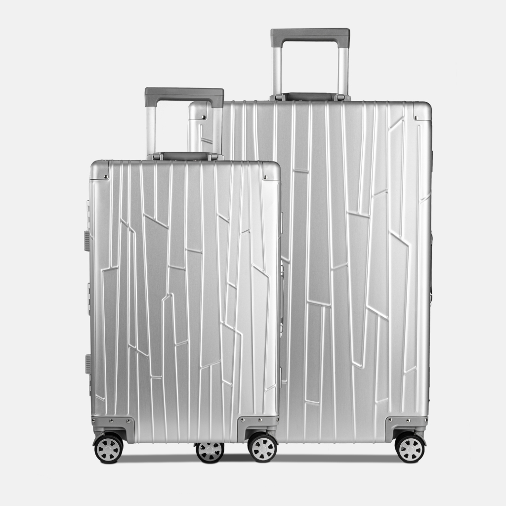 Preview: Zwei GUNDEL Koffer in silver in Frontansicht mit Linienmuster und Teleskopgriffen - stehen nebeneinander vor weißem Hintergrund.